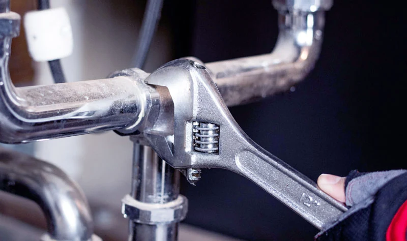 Plumbing tools at a pipe connection